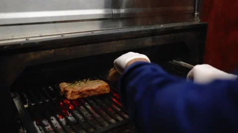The chef fries two delicious steaks. Stock Footage 145855641