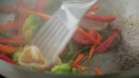 Chef fries vegetables, squid and shrimp in a wok pan Stock Footage 127205346