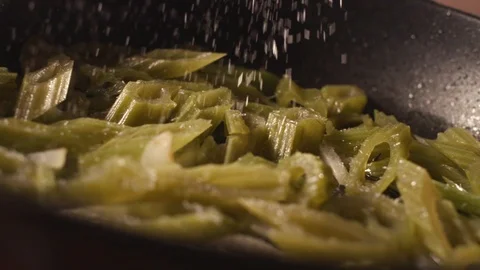 Chef fry edible burdock in a pan in a restaurant Stock Footage 119189853