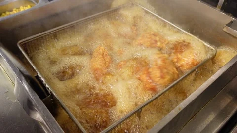 Chef Frying Bone-In Chicken Pieces in a Deep Fryer at Fast Food Kitchen Stock Footage 340477593