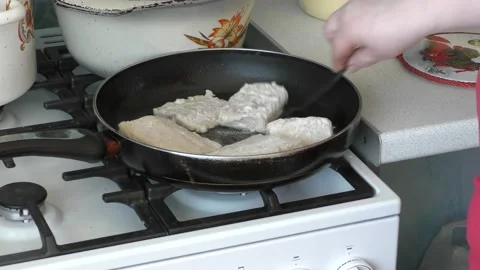 Chef frying fish in a frying pan Stock Footage 177154338