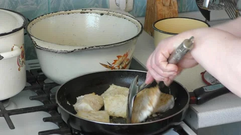 Chef frying fish in a pan Stock Footage 171984527