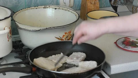 Chef frying fish in a pan Stock Footage 172361378