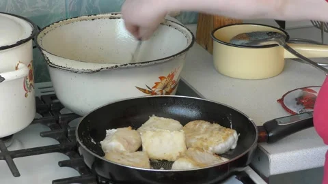 Chef frying fish in a pan Stock Footage 172365376
