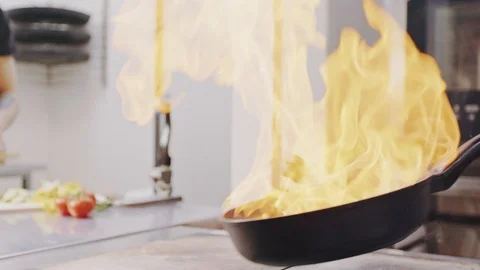 Chef Frying ingridients On Fire Throwing Them In A Frying Pan Видео 104720079