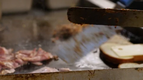 Chef is frying meat and bacon on smooth pan Stock-Footage 127600959