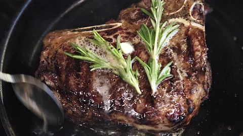The chef is frying meat Stock Footage 130988820