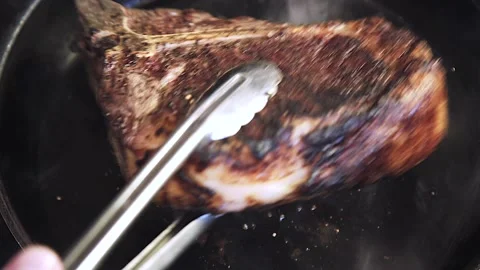 The chef is frying meat Stock Footage 130988856