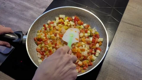 The chef is frying a mixture of vegetables in a frying pan. Stock Footage 231697125
