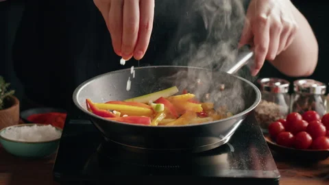 Chef frying pepper in pan close-up. Woman chief cooking dish with grilled Stock Footage 169734636