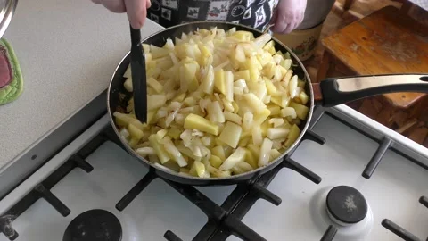 Chef frying potatoes in a frying pan Stock Footage 180581553