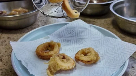 A chef is frying squid rings in a pan Stock Footage 307155608
