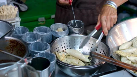 A chef is frying squid rings in a pan Stock Footage 318979559