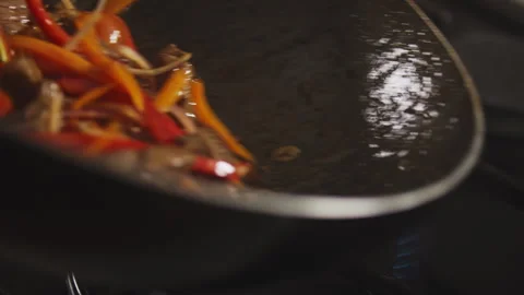 Chef frying vegetables and meat in a frying pan Stock Footage 274670526