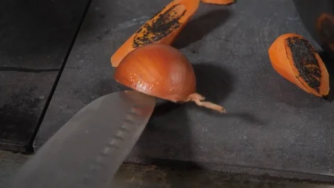 Chef is frying vegetables and vegetables on stove. Carrots and onion fry until Stock Footage 84877684
