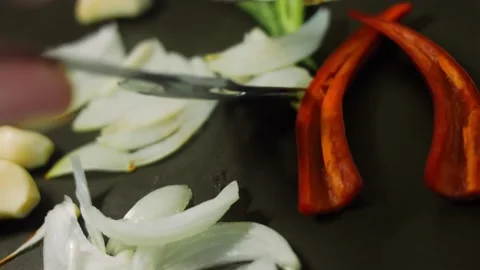 The chef is frying vegetables. Brown red and green onions and peppers. Turn the Stock Footage 196817054