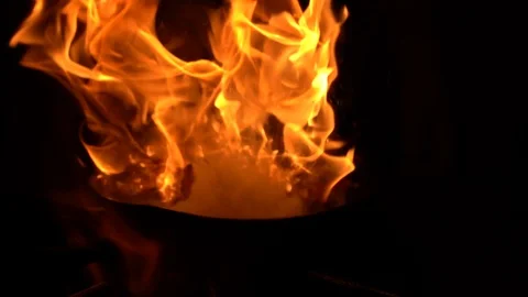 Chef frying vegetables on fire throwing them in a frying pan. Slow motion Stock Footage 116793362