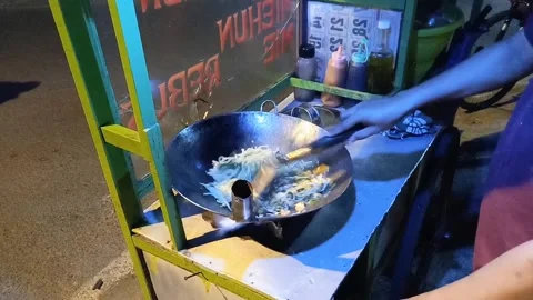 The chef is frying vegetables in the form of cabbage, mustard greens, carrots Stock Footage 287327413