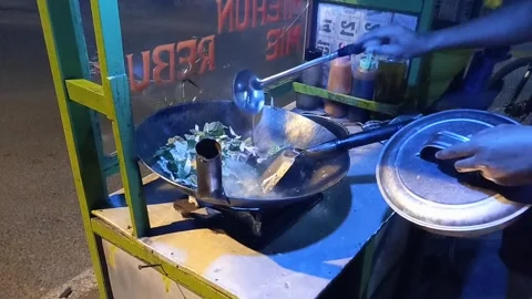 Chef is frying vegetables in the form of cabbage, mustard greens, carrots Stock Footage 287327420