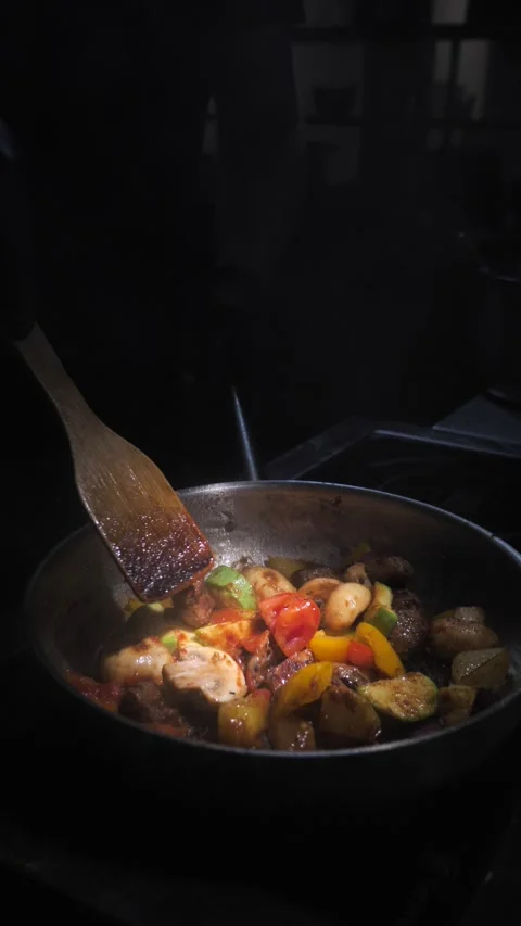 Chef frying vegetables with meat mixing in a frying pan. Chef cooking Stock Footage 309463164