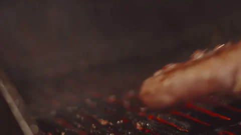 Chef Gently Flipping Steak on BBQ with Fire Flames Erupting from Beneath. Stock Footage 342270219