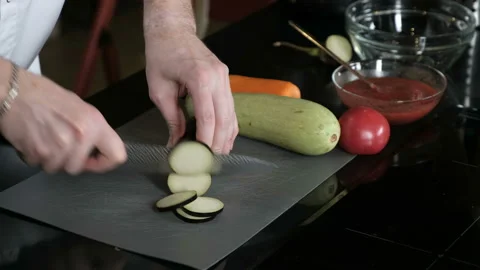 Chef gently slices eggplant Stock Footage 96379767