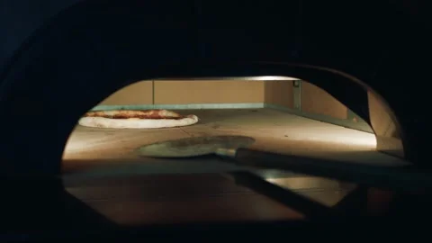 Chef gets ready pizza out of the oven Stock Footage 134050377
