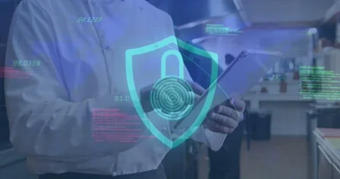 Chef glancing at tablet, raising tablet, tapping while securing data with shield Stock Footage 333903332