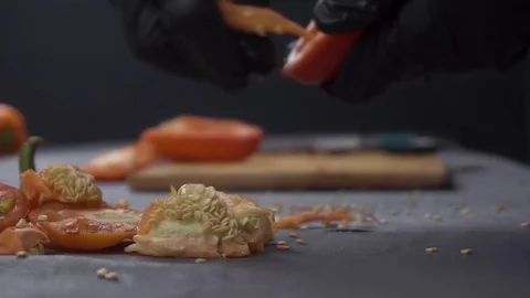 Chef in gloves cuts bell pepper Stock Footage 116505109