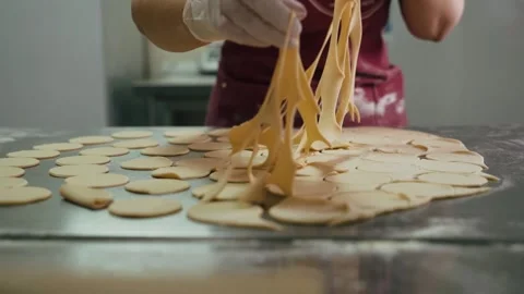 Chef in gloves cuts dough for dumplings Stock Footage 155203058