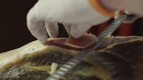 A chef in gloves cuts ham with a knife. Close-up Stock Footage 157810868