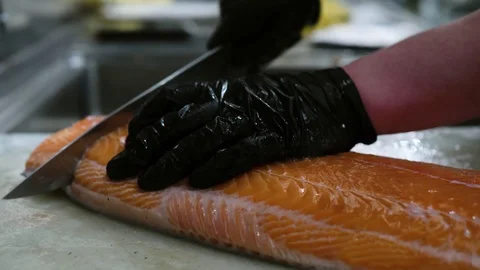 Chef with Gloves Cuts Salmon Stock-Footage 128927291