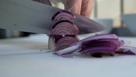 Chef in gloves cuts violet onion on the white cuttung board. Stock Footage 132769900