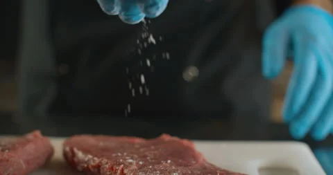 Chef with gloves salt beef steak. 4k slow motion video Stock Footage 103540344
