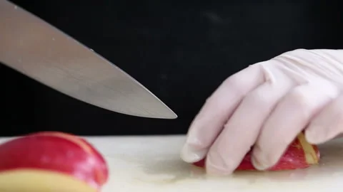 Chef in gloves slicing apple 스톡 동영상 98644322