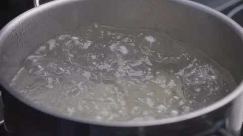 Chef in gloves throws khinkali into saucepan of boiling water. Stock Footage 314971470