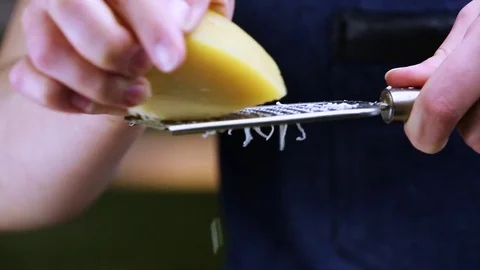 Chef grate cheese on the grater Stock Footage 73765177