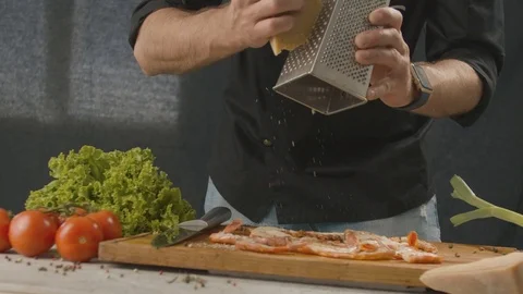 Chef grate the parmesan on the shrimp. 120 fps slow motion video Stock Footage 112283681