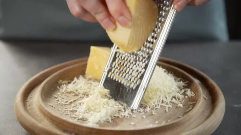 Chef grates cheese for making pie grated cheese Video stock 143778290
