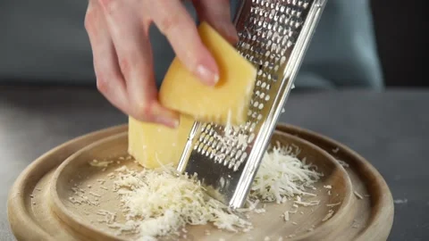 Chef grates cheese for making pie grated cheese Stock Footage 143778340