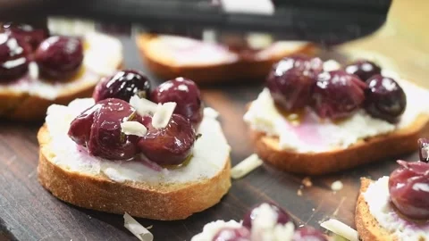 The chef grates roasted hazelnuts on the bruschetta. Stock Footage 202176818
