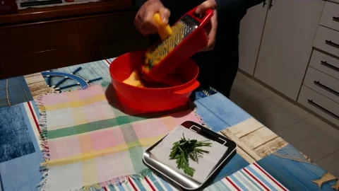 The chef grates the yellow squash for the preparation of pancakes Video stock 146028928