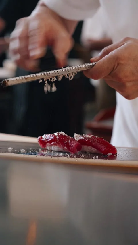Chef grating black truffle over fresh bluefin tuna Stock Footage 314682785