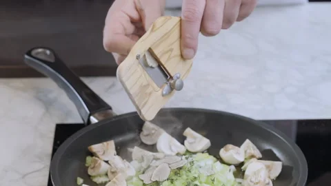 Chef grating black truffle on slices in a pan to prepare the white sauce. Stock Footage 271613143
