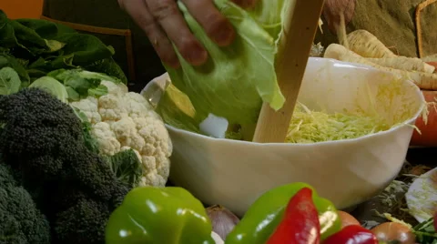 Chef grating cabbage for salad with grater in kitchen, dolly, close up. Stock Footage 60598225