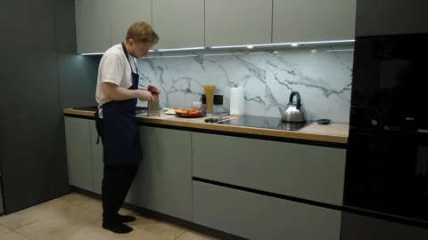 Chef Grating a Carrot in the Kitchen Stock Footage 324528821