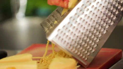 Chef grating cheddar cheese for cooking. Stock Footage 145240186