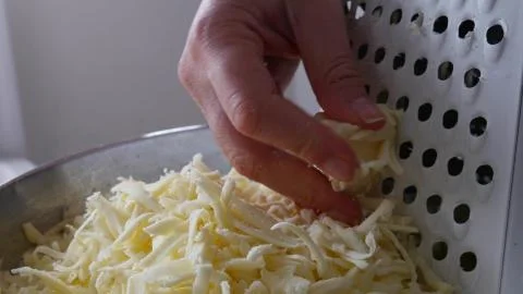 Chef grating cheese for pizza, close up Stock Photos