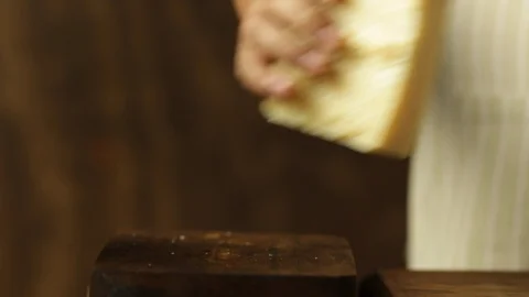 Chef Grating Cheese on a Wooden Surface Stock Footage 86124424