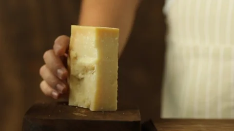 Chef Grating Cheese on a Wooden Surface Stock Footage 86125414